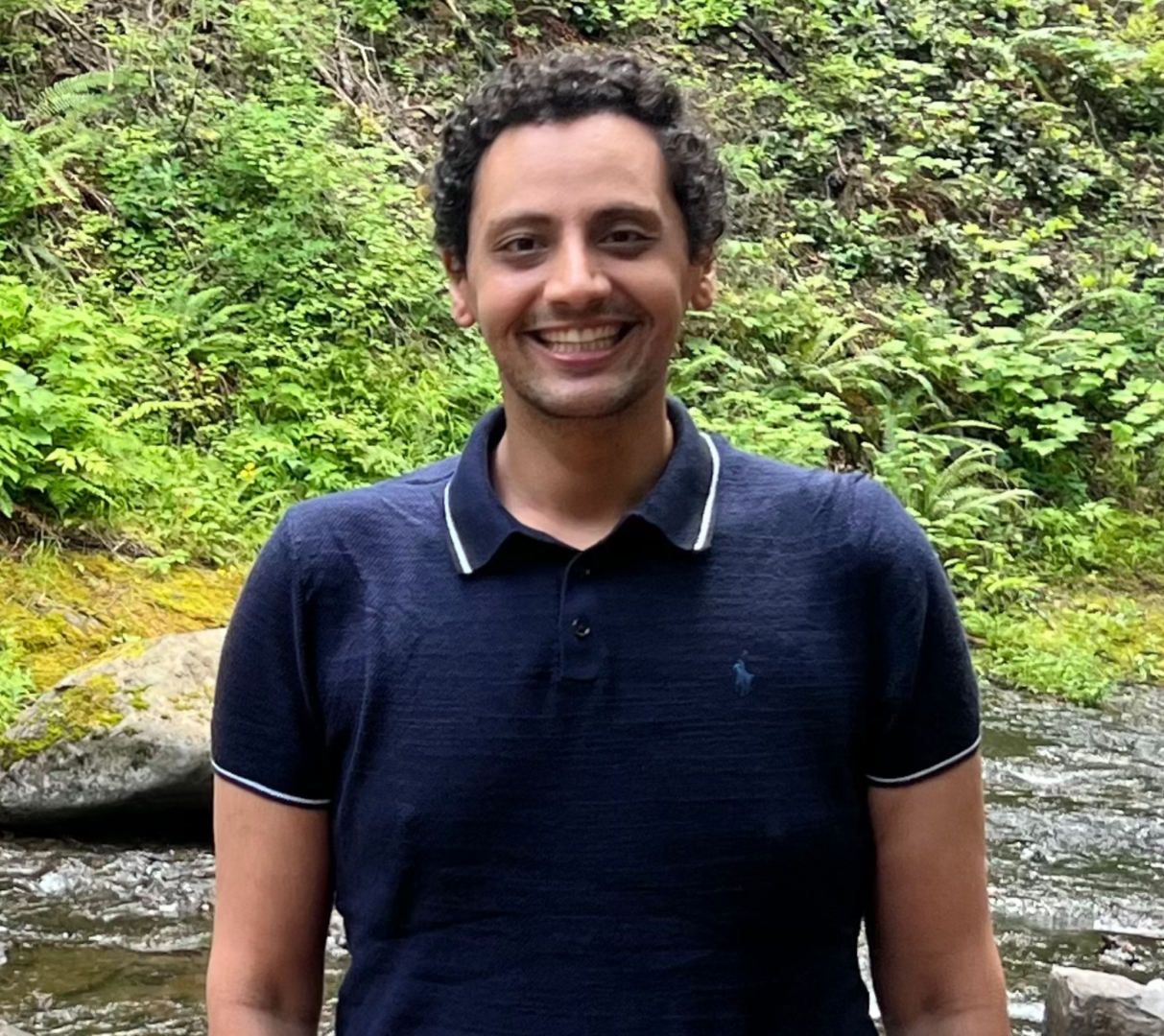 Man in blue polo shirt outdoors.