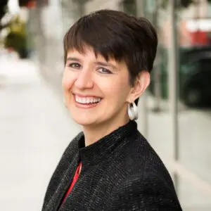 Smiling woman wearing a black jacket.