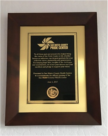 A plaque with the words " state of north county pride center ".