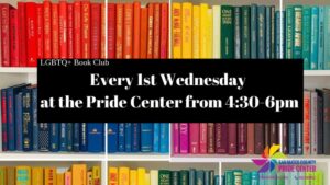 A rainbow of books in front of a white background.