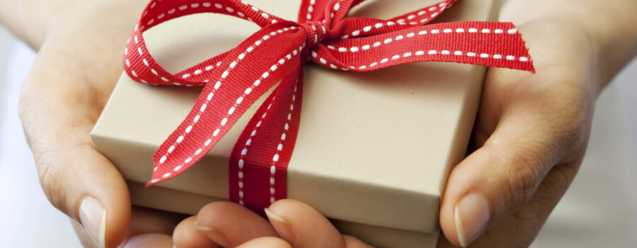 A person holding a gift box in their hands.